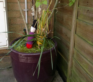 Doll in flower pot