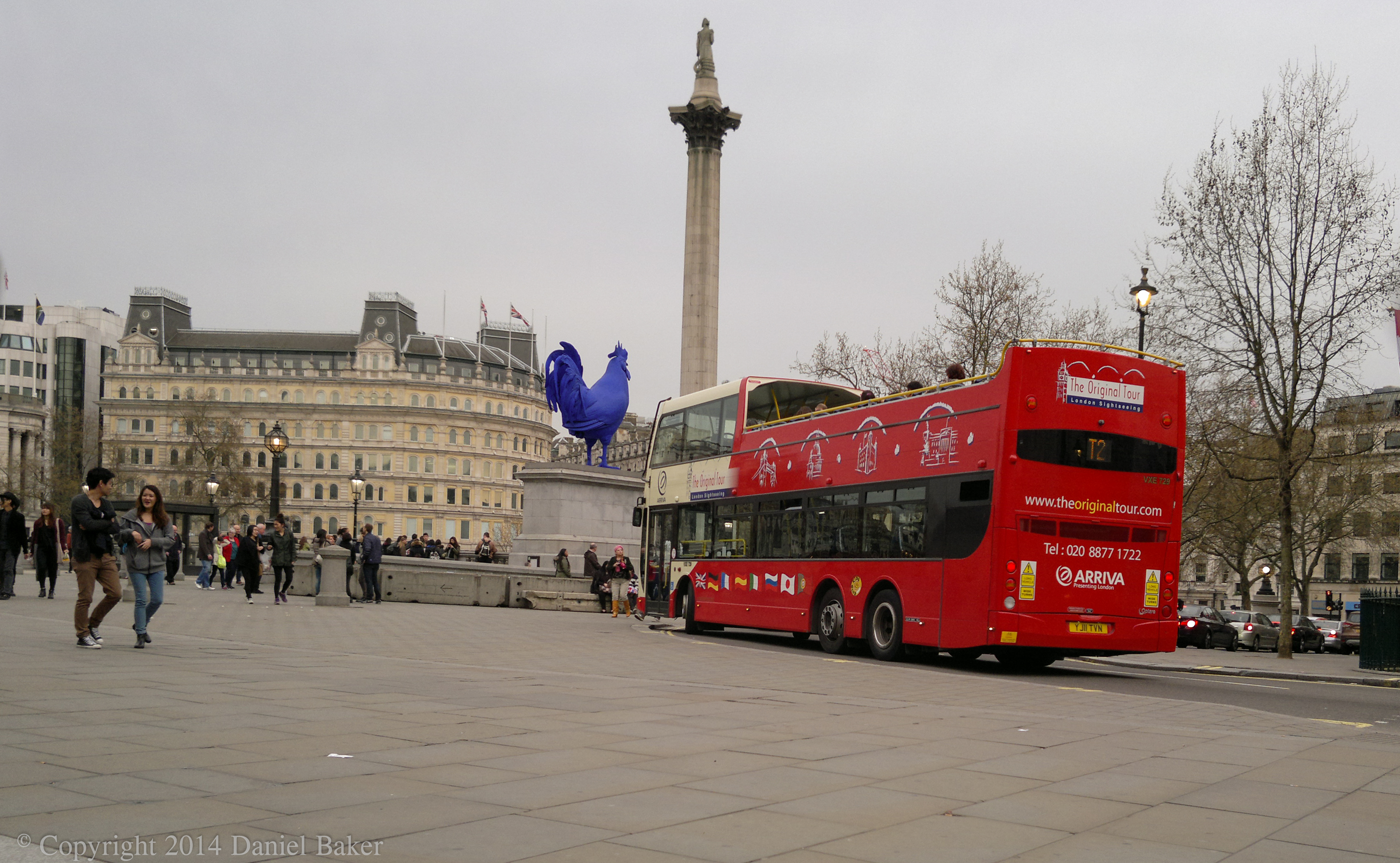 Trafalgar square with blue chicken statue and red bus