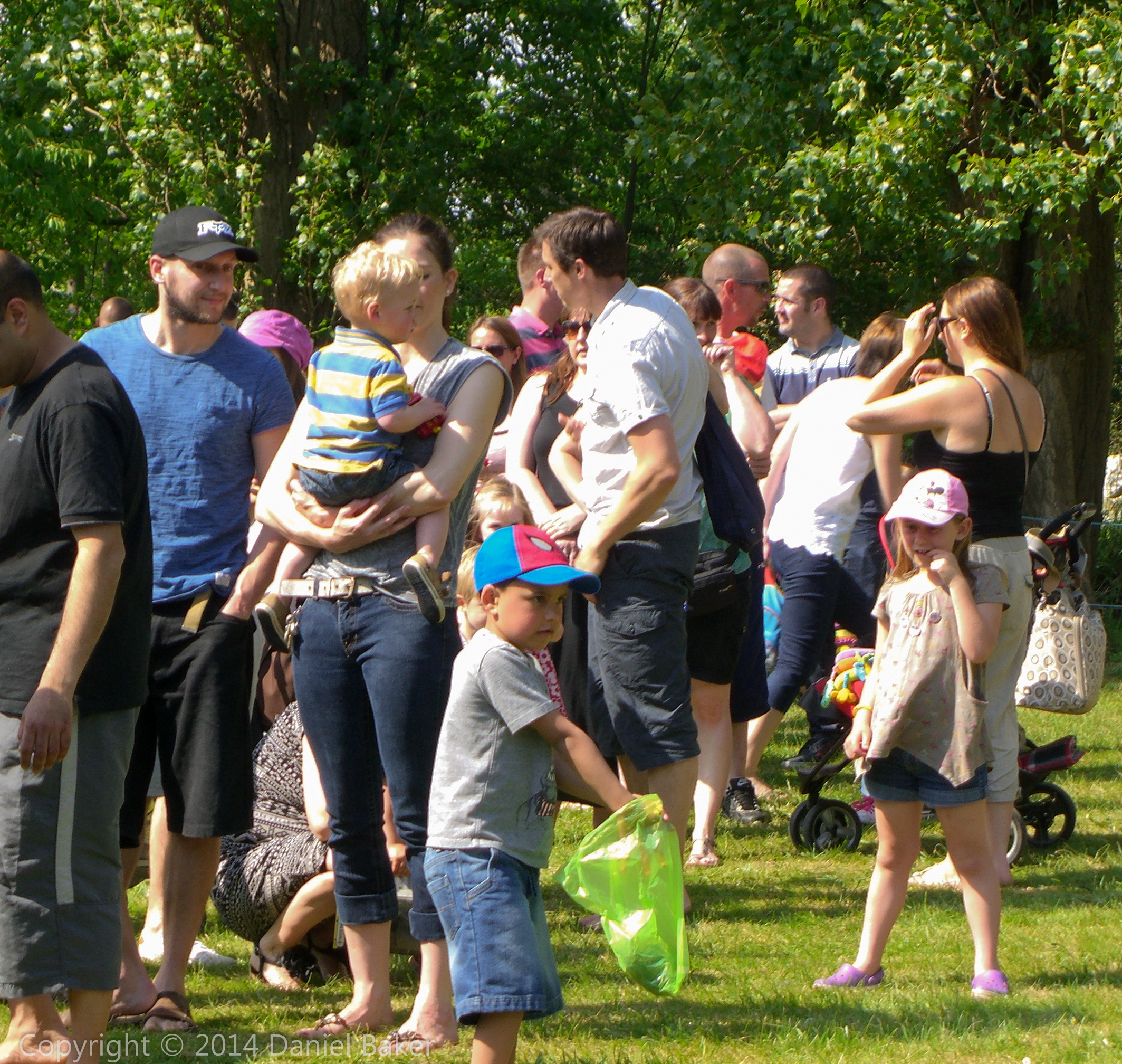 lots of people at a model railway on a sunny day