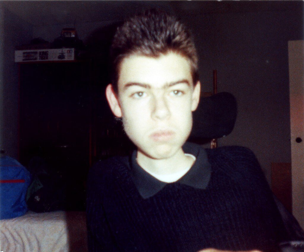 A picture of me as a teenager in a black jumper
