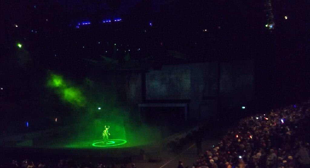 Loki on stage bathed in a green glow at Marvel Universe Live