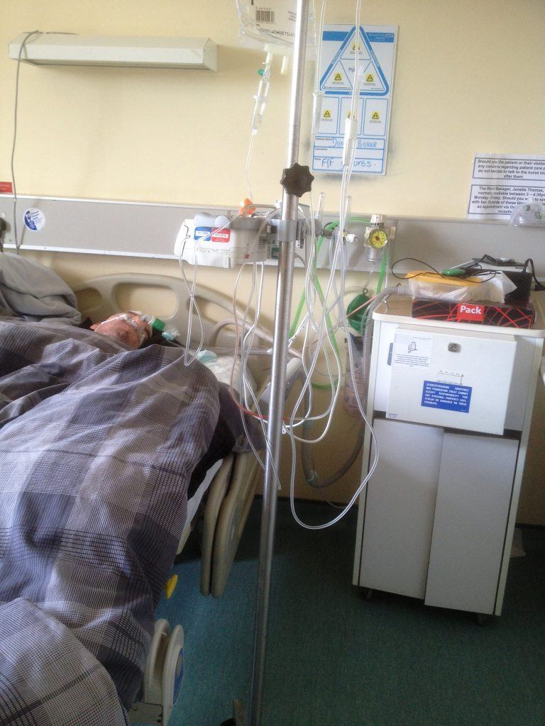 Daniel Baker laying in a hospital bed at Gloucester Royal Hospital