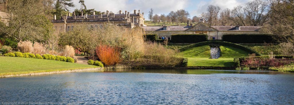 view across the lake and landscaped garden to the small waterfall at Dyrham Park