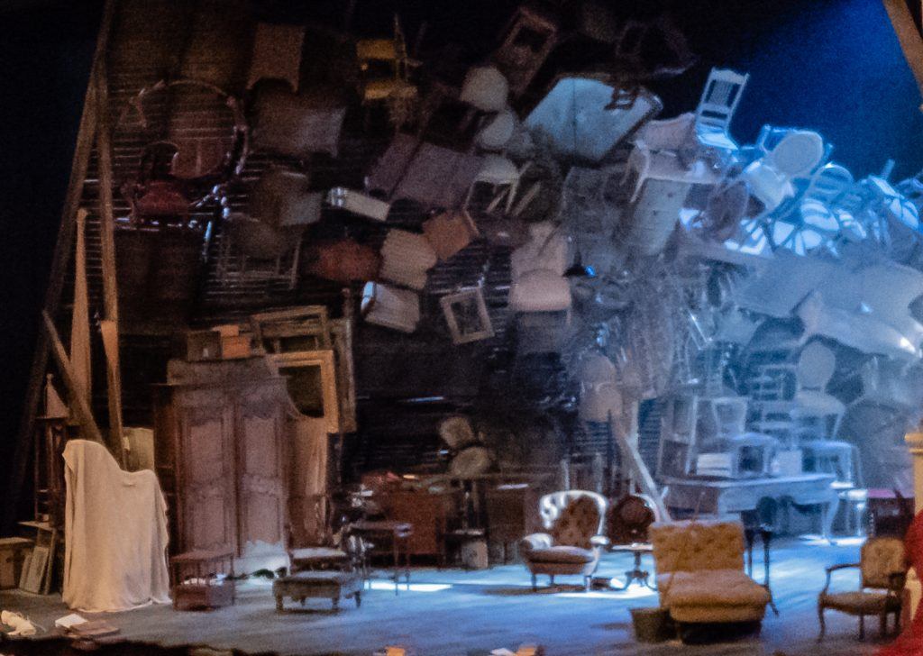 The Price set, an attic full of stacked up furniture