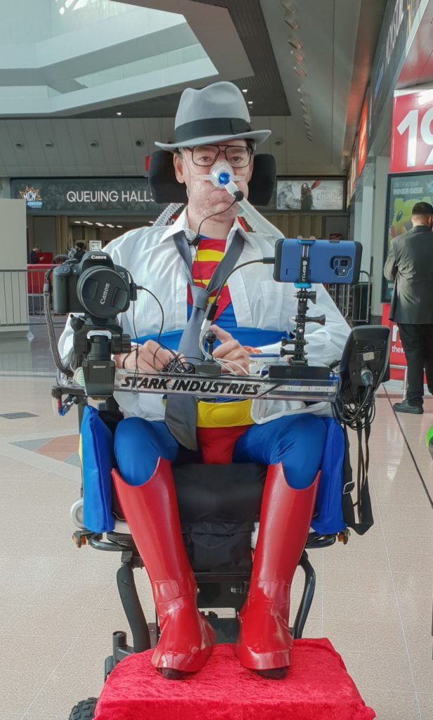 Daniel Baker dressed as Clark Kent with Superman costume under white shirt at MCM Comiccon November 2018