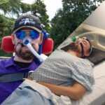 two photos, one of Daniel wearing a baseball cap, sunglasses and a purple polo shirt at Westonbirt Arboretum and another of Daniel in a hospital gown laying in a hospital bed