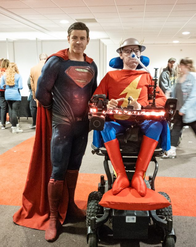 Daniel Baker dressed as Jay Garrick "The Flash" with a Superman cosplayer standing next to him