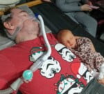 Daniel Baker With Reme-Rose laying in the crook of his arm