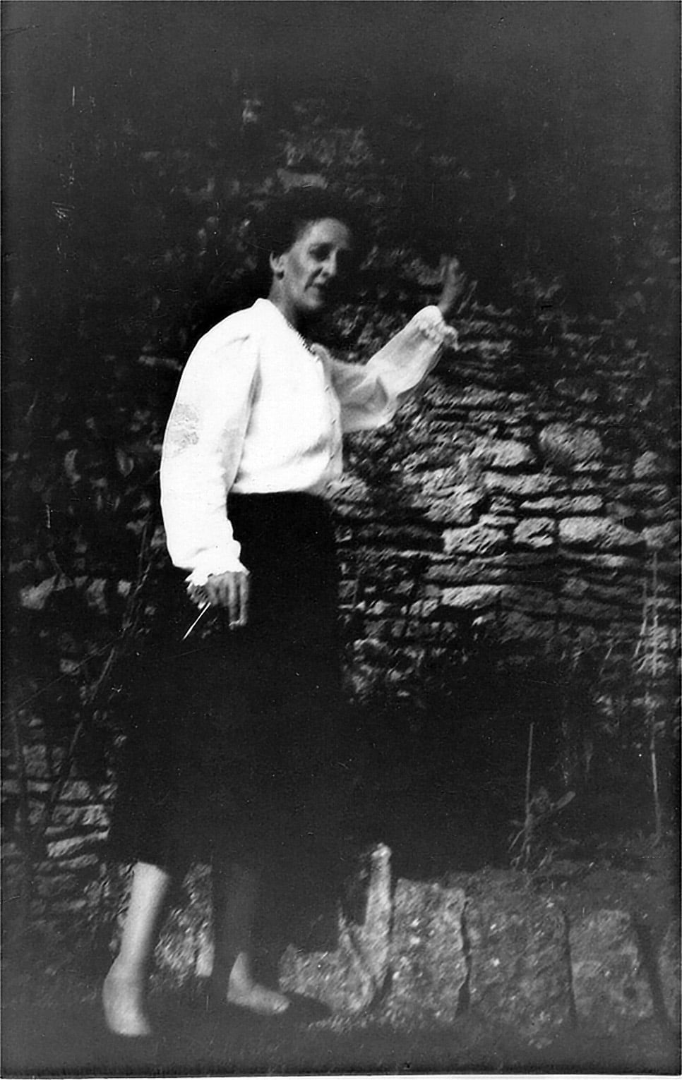 Black and white photo of a woman in a garden