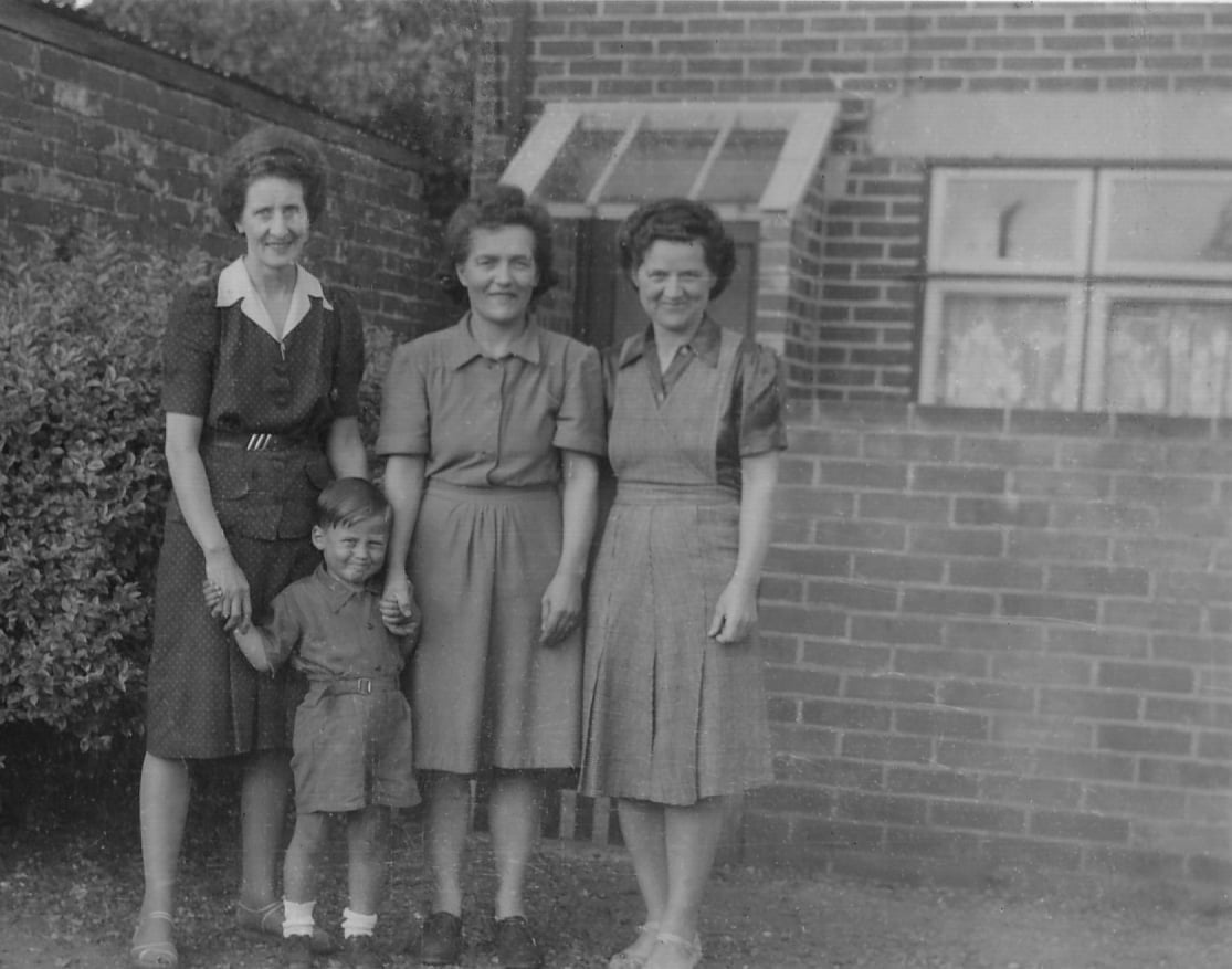 Black and White photo of three women and a child