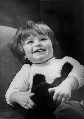 Black and white picture of a very young Daniel Baker smiling