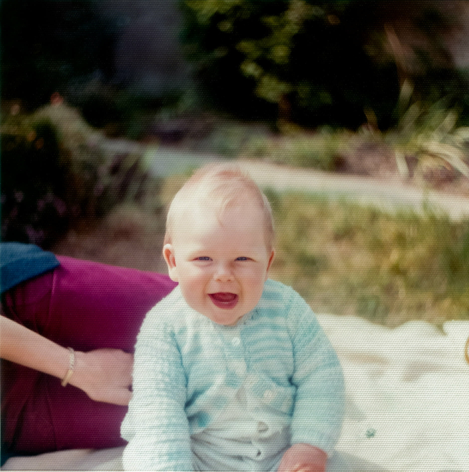 A very young Daniel Baker sitting in a park