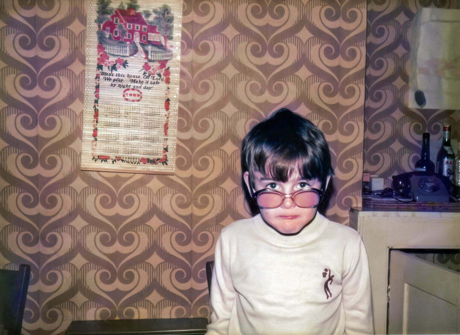 A young Daniel Baker wearing 1970's style sunglasses