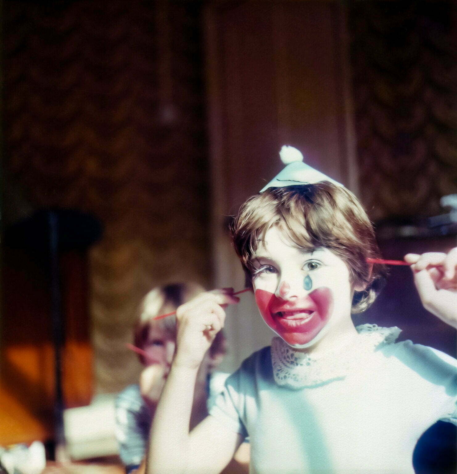A young Daniel Baker with clown face paint